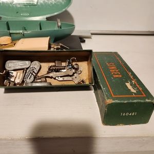 Vintage Singer button holer with extra attachments.